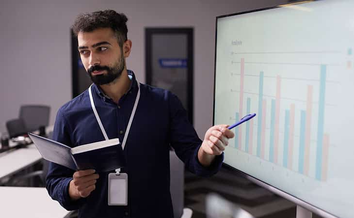 man-pointing-data-board